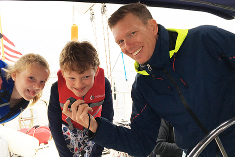 Captain Chris teaches Ryan to talk on the VHF