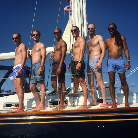 Group of men in a line aboard Moment sailboat